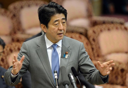Japan's Prime Minister Shinzo Abe (front C) smiles during the ruling Liberal Democratic Party (LDP) annual convention in Tokyo March 17, 2013.